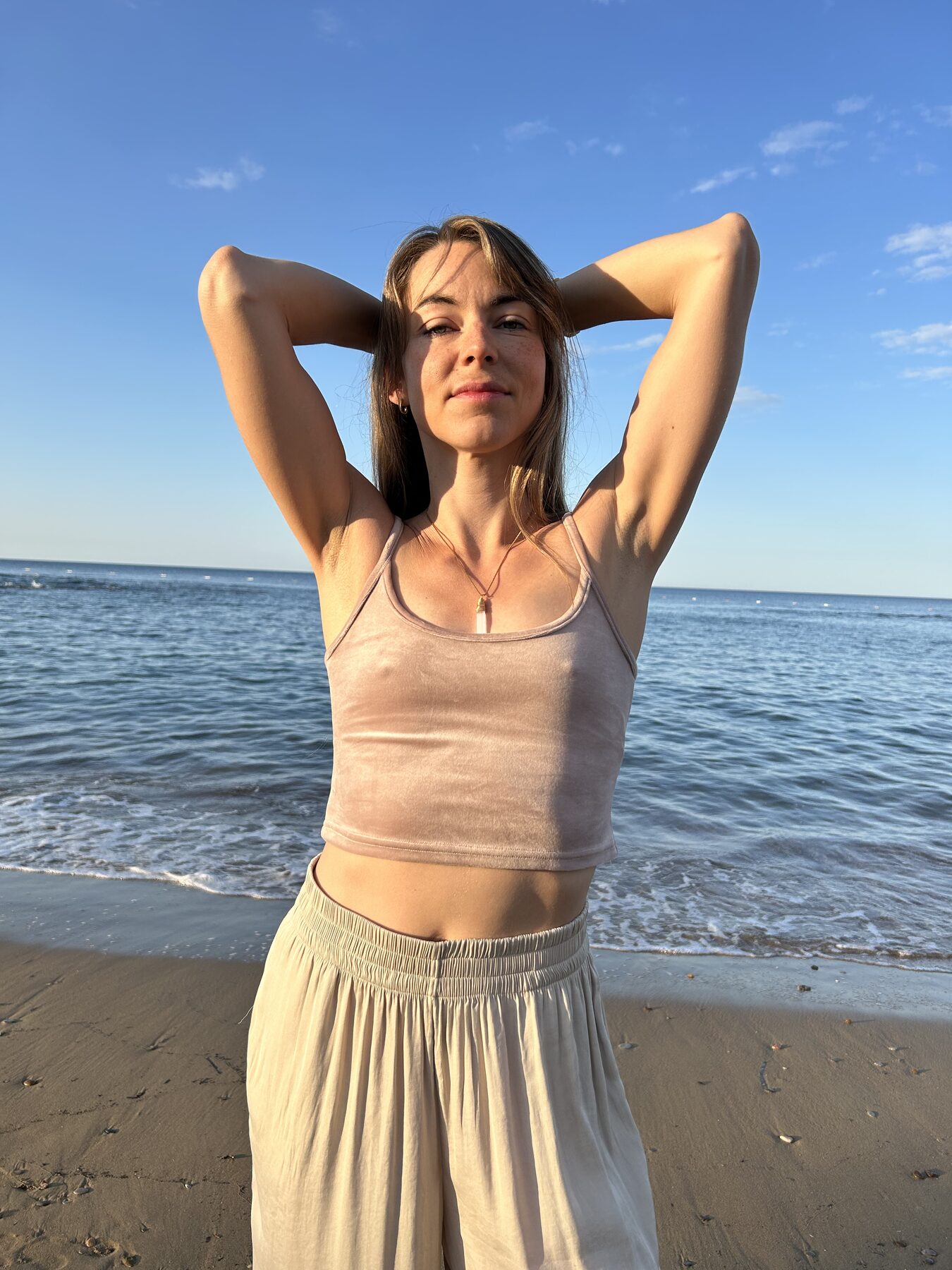 Coach kneeling on the beach, soft warm light, present